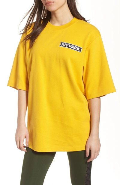 Ivy Park Flag Badge Tee In Old Gold