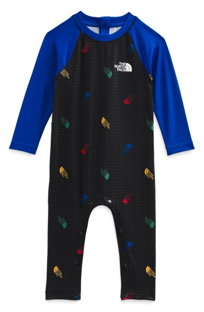 The North Face Babies' Amphibious Sun Romper In Tnf Black Tossed Logo Grid Print