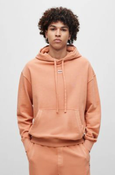 Hugo Cotton-terry Relaxed-fit Hoodie With Logo Patch In Light Orange