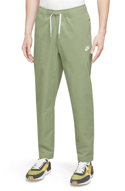 Nike Men's Club Woven Tapered Leg Pants In Oil Green/white