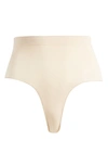 Skims Sculpting Seamless Mid Waist Thong In Sand