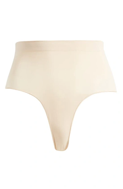 Skims Sculpting Seamless Mid Waist Thong In Sand