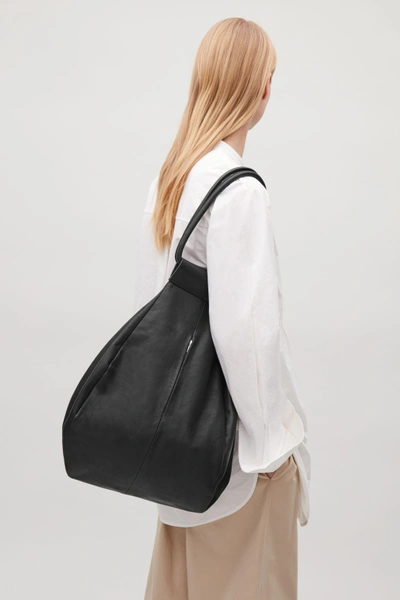 cos soft folded leather backpack including a pair of oversized pockets at the front COS Navy Medium Soft Leather