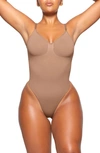 Skims Seamless Sculpt Low Back Thong Bodysuit In Sienna
