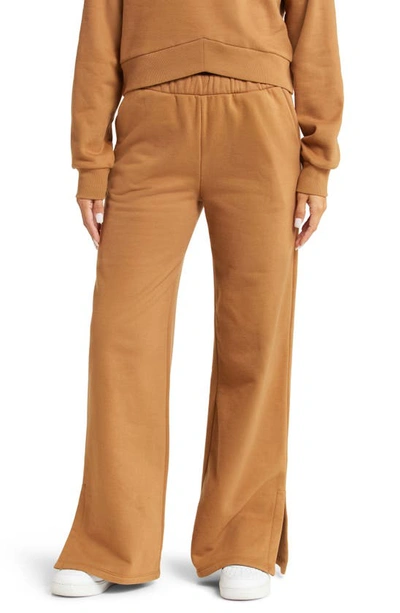 Beyond Yoga On The Go Wide Leg Flare Trousers In Toffee