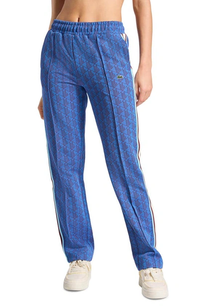 Lacoste Logo Monogram Stripe Track Trousers In Blue