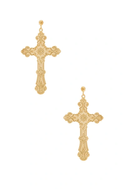 Amber Sceats Cross Earrings In Metallic Gold.