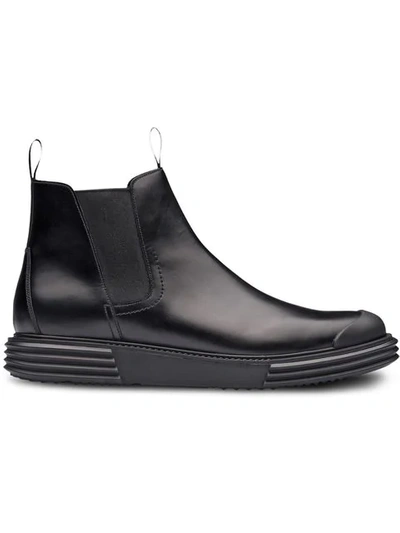 Prada Lug Sole Ankle Boots In Black