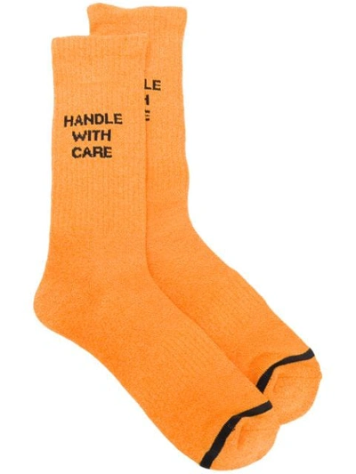 Necessary Anywhere Handle With Care Socks In Orange