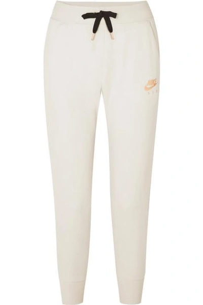 Nike Air Rally Printed Cotton-blend Fleece Track Pants In Cream