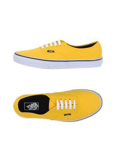 solid yellow vans slip on
