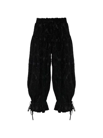 Ganni Pleated Frayed-effect Trousers In Black