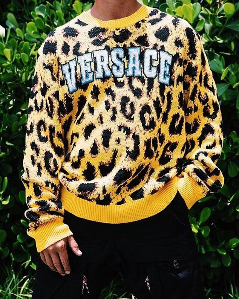 STAY INDOORS | Wearing: Versace Leopard-print Logo Sweater In Yellow; Burberry Combat Trousers In Black
