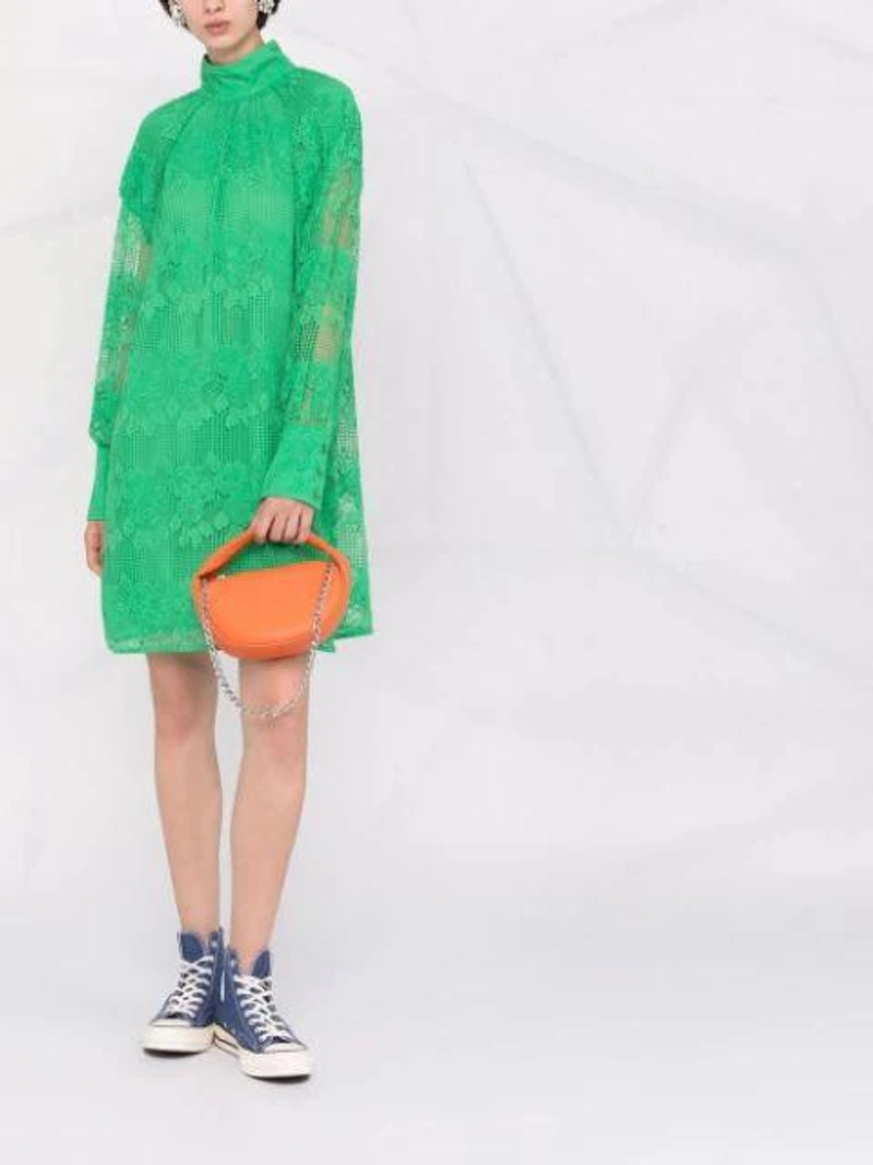 Farfetch's Post | Wearing: Ganni Floral-lace Shift Dress In Green; By Far Baby Cush Papaya Leather Handbag With Chain In Orange; Alessandra Rich Silver Tone Square Crystal Clip Earrings In Metallic