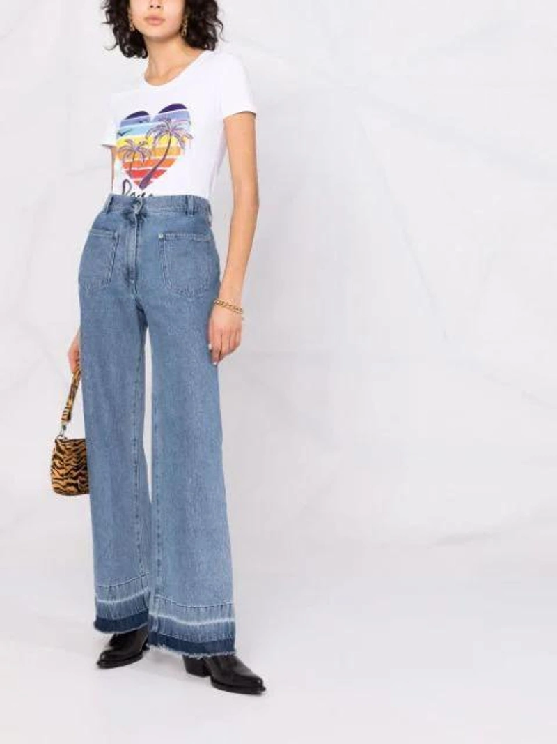 Farfetch's Post | Wearing: Love Moschino Palm Tree Print T-shirt In White; Jw Anderson High-waist Flared Jeans In Blue; By Far Brown Rachel Tiger Pattern Shoulder Bag