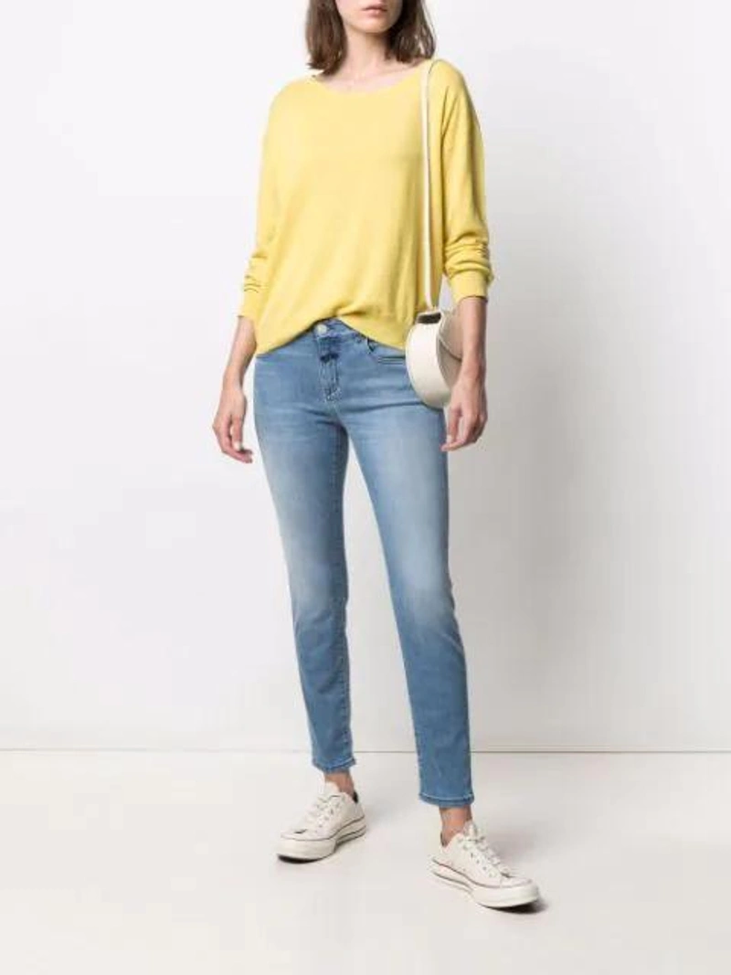Farfetch's Post | Wearing: Closed Baker Medium Blue Skinny Leg Jean; Converse Chuck 70 Classic Low-top Sneakers In Light Beige; Closed Crew-neck Fittted Jumper In Yellow