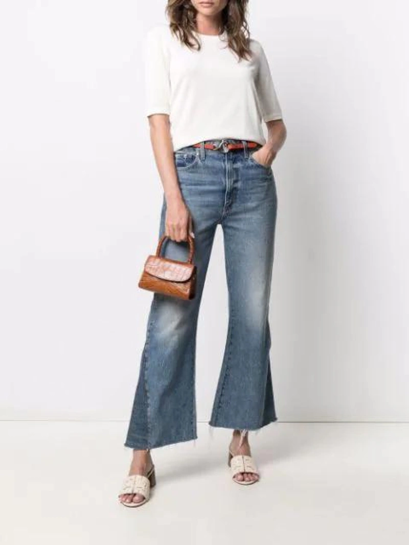 Farfetch's Post | Wearing: Drumohr Short-sleeved Cotton T-shirt In Neutrals; Khaite Layla Cropped-leg Flared Jeans In Blue; Chloé Orange C Buckle Leather Belt