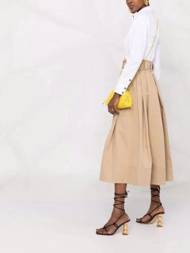 Farfetch's Post | Wearing: Patou Belted Cotton Midi Skirt In Neutrals; Ganni Shirred Cotton Poplin Blouse In Bright White; Bottega Veneta The Pouch Mini Bag In Mirabelle Color In Yellow