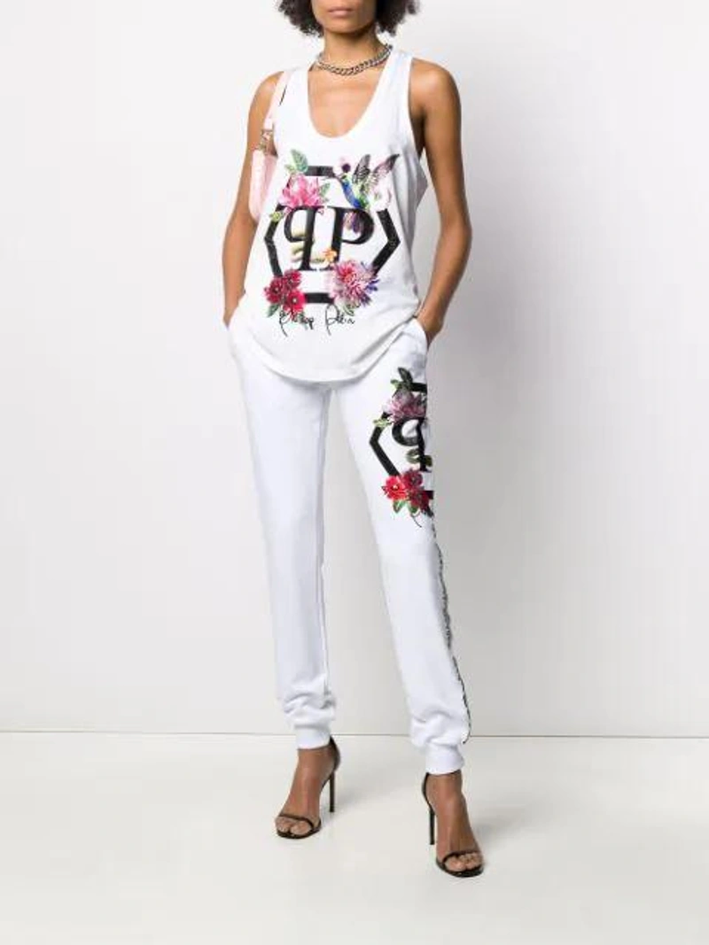 Farfetch's Post | Wearing: Philipp Plein Embellished Floral Tank Top In White; Alessandra Rich Silver Tone Cascade Crystal Earrings In Metallic