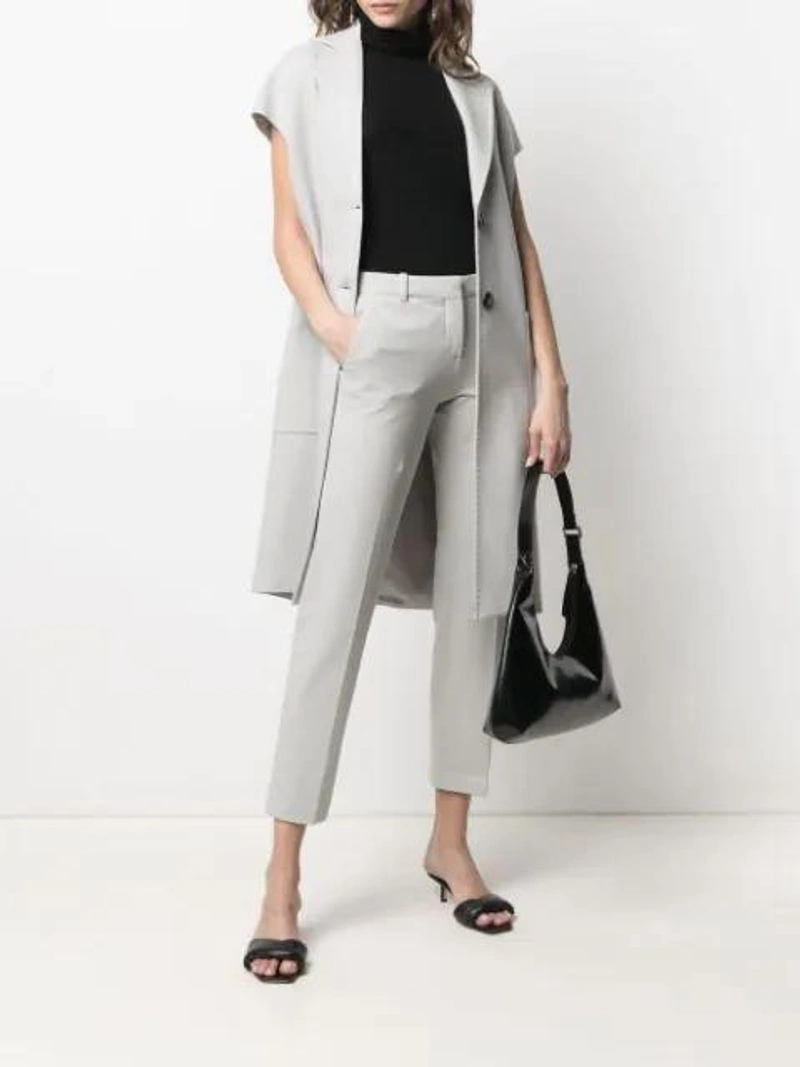Farfetch's Post | Wearing: Circolo 1901 Cap-sleeves Buttoned-up Coat In Grey; Tibi Wool Turtleneck Sleeveless Sweater In Black; Circolo 1901 Tapered Slim-cut Trousers In Grey