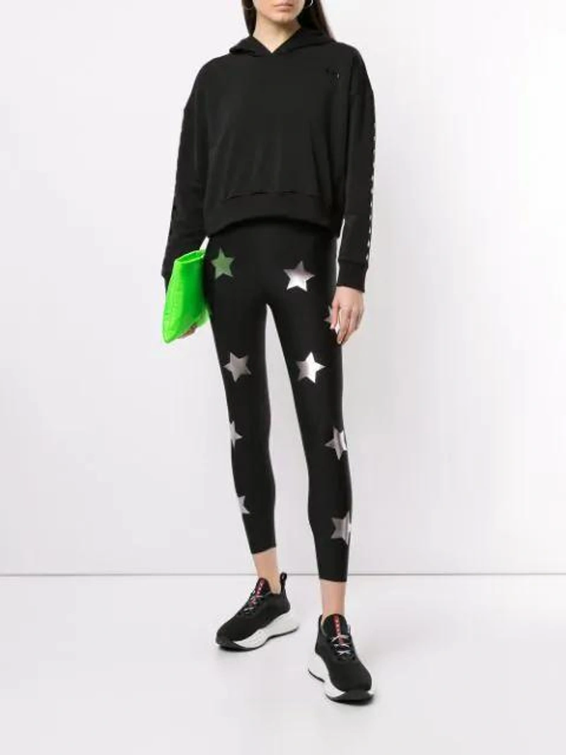 Farfetch's Post | Wearing: Ultracor Ultra High-waist Python Print Leggings In White Transparent Lucido; Ultracor Women's Patent Star Cropped Hoodie In Nero Patent; Prada Clutch In Green
