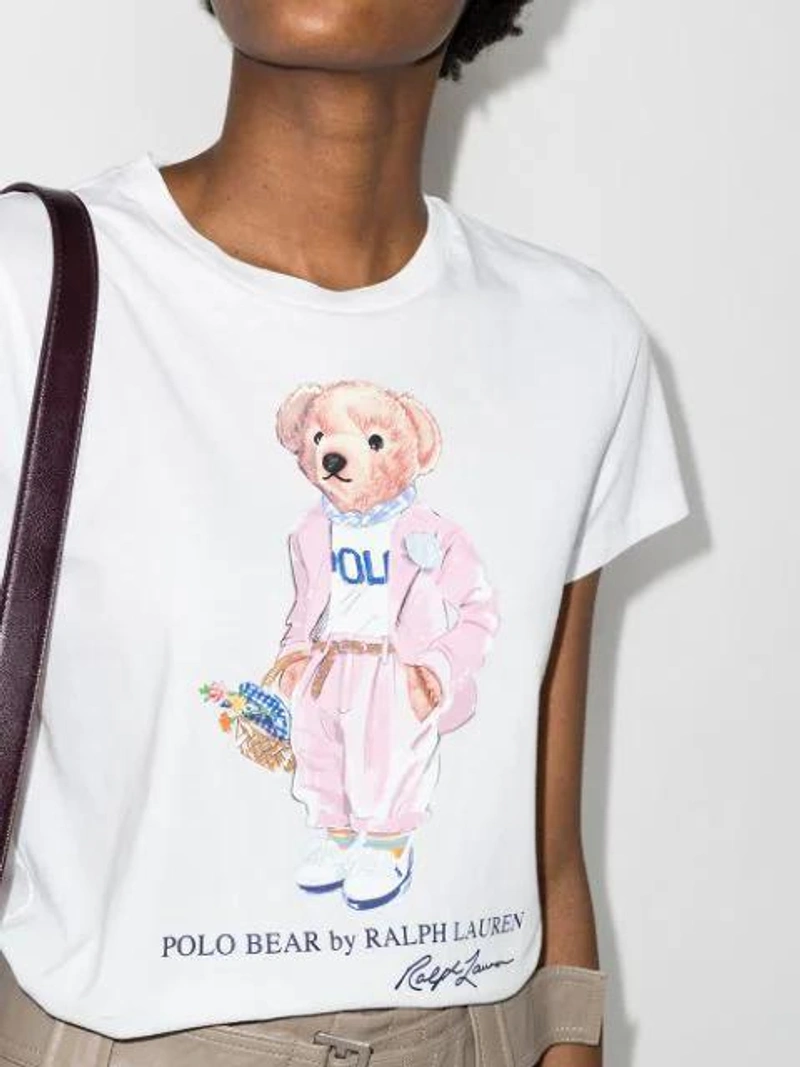 Farfetch's Post | Wearing: Polo Ralph Lauren Floral Picnic Bear Graphic Tee In White; Ganni High-rise Flared Shorts In Neutrals; Marni Hooded Contrast Ruched-sleeve Coat In Neutrals