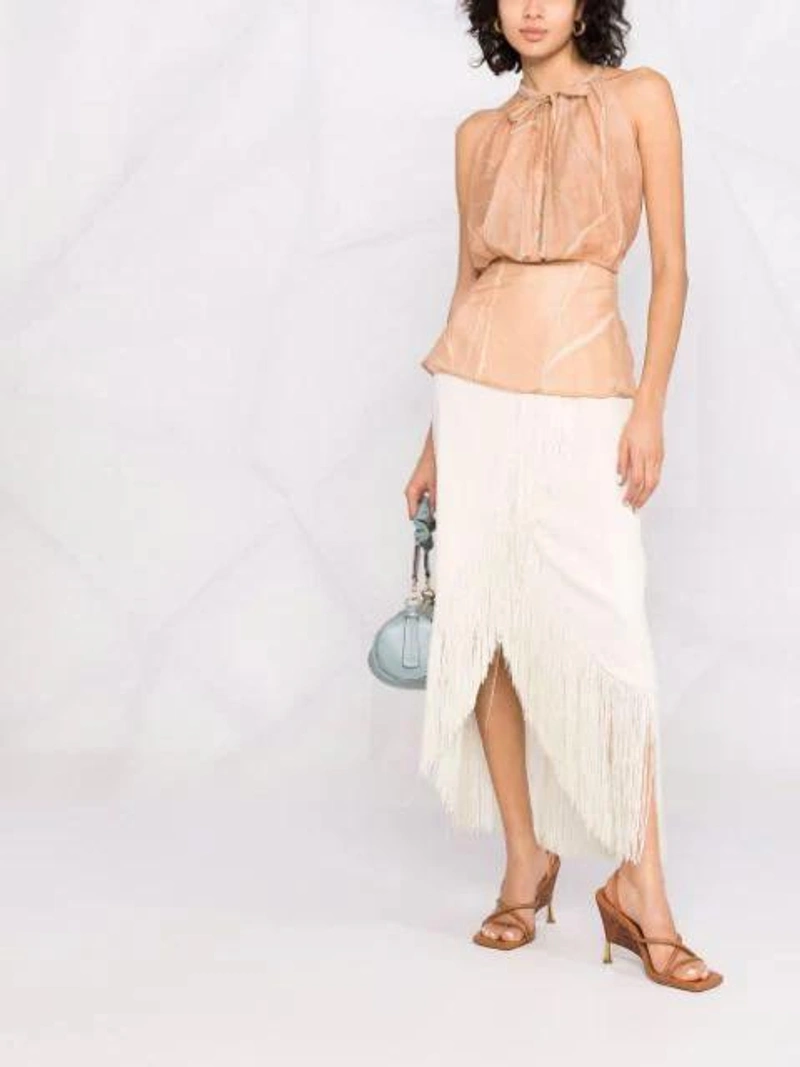 Farfetch's Post | Wearing: Alysi Sleeveless Fitted-waist Blouse In Neutrals; Taller Marmo El Pareo Fringe Hem Skirt In White; Manu Atelier Cylinder Ruched Shoulder Bag In Blue