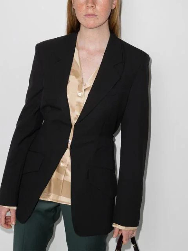 Farfetch's Post | Wearing: Totême Monogram-embroidered Silk Pajama Top In Ivory Monogram; Nanushka Button-front Tailored Blazer In Black; Lvir Green Slit Bell Bottom Trousers