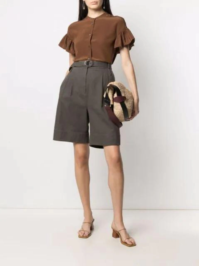 Farfetch's Post | Wearing: Aspesi Ruffled Sleeves Silk Blouse In Brown; Tibi Khaki Gabardine Stella Shorts In Green Grey; Isabel Marant Bayia Raffia Tote Bag In Neutrals