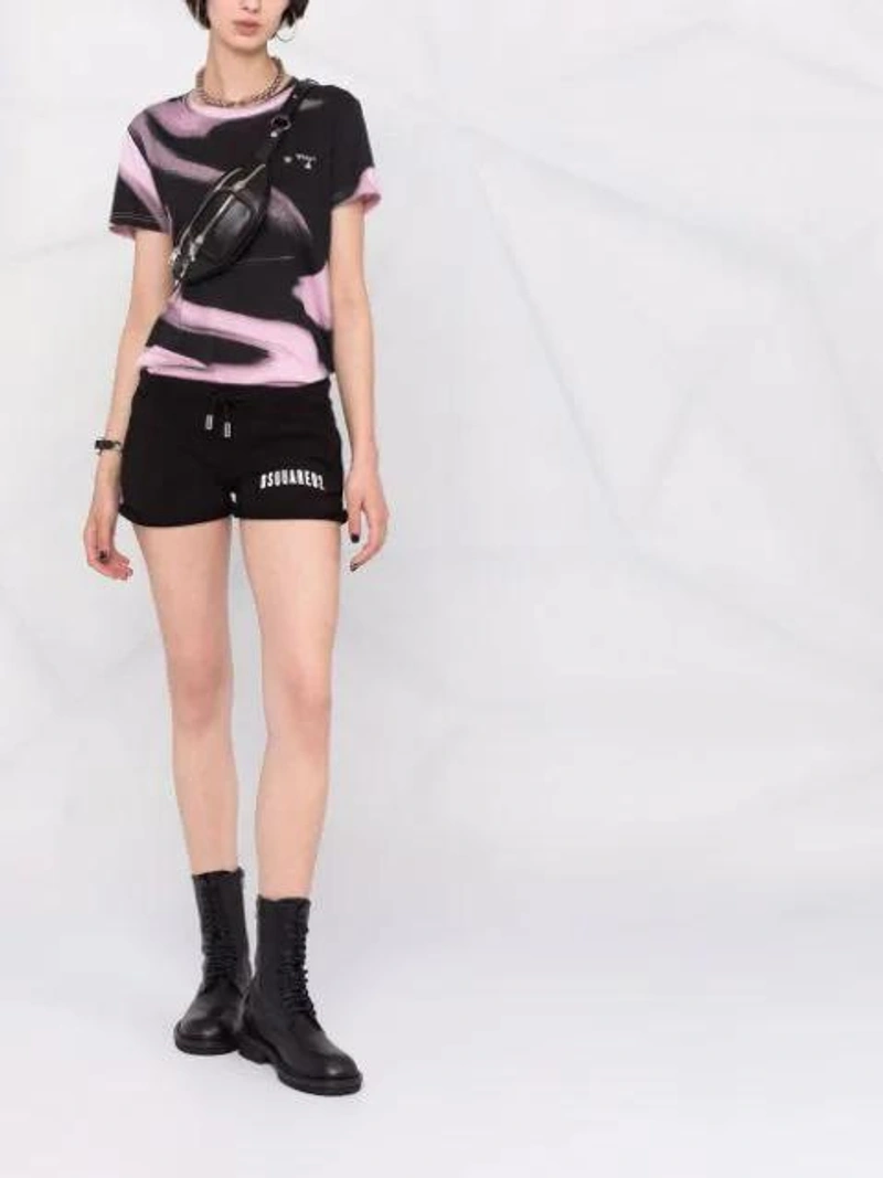 Farfetch's Post | Wearing: Ann Demeulemeester Lace-up Leather Ankle Boots In Black; Dsquared2 Jersey Shorts With Logo Print In Black; Off-white Liquid Short-sleeve T-shirt In Black