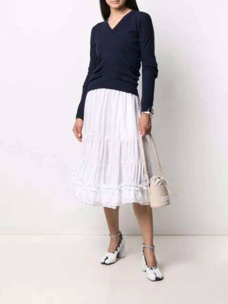 Farfetch's Post | Wearing: Comme Des Garcons Girl White Cotton Ruched Detail Skirt; Maison Margiela Ruched V-neck Pullover In Blue; Maison Margiela Neutral 5ac Leather Mini Bucket Bag In Nude