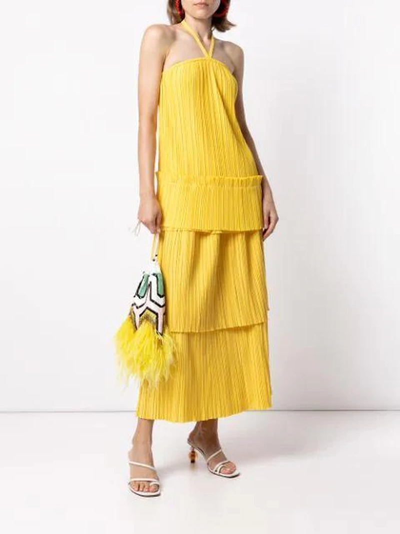 Farfetch's Post | Wearing: Bambah Tiered Layered Plissé Twill Midi Skirt In Yellow; Bambah Plissé-twill Halterneck Top In Yellow