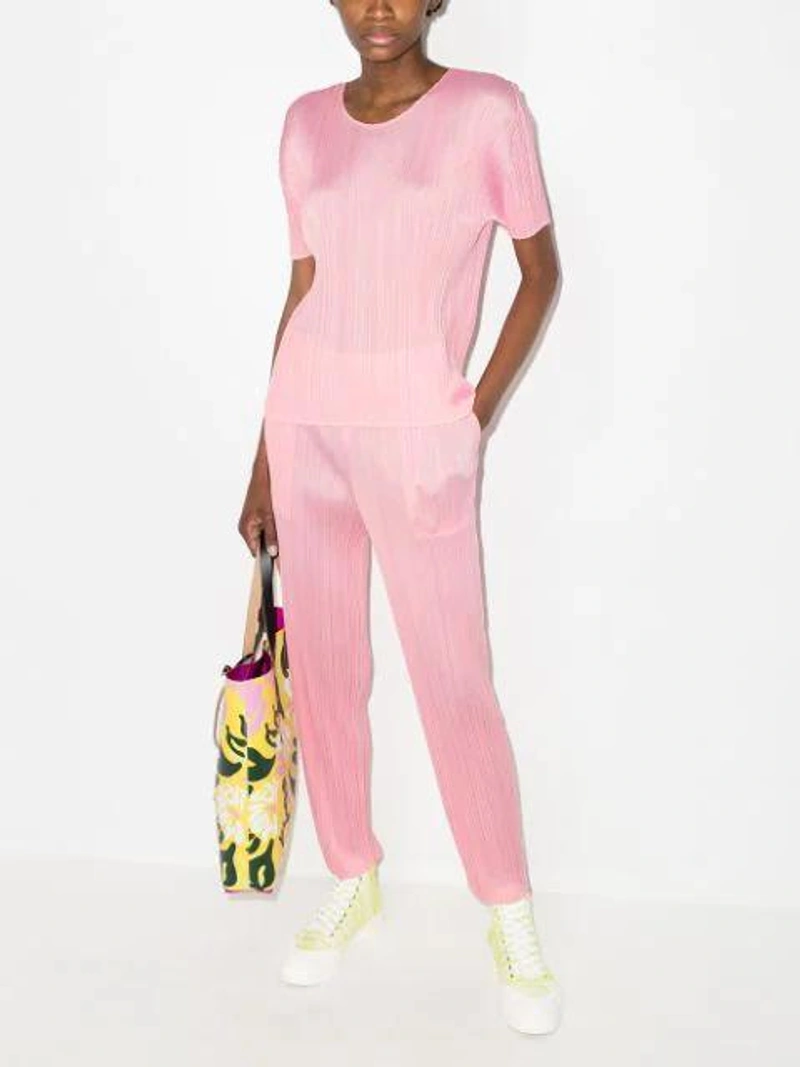 Farfetch's Post | Wearing: Issey Miyake Pink Monthly Colors March T-shirt In 22-pink; Issey Miyake Pink Slim Leg Plissé Trousers; Marni Yellow & Pink Euphoria Print Tote In Z2n79 Maize+cassis+