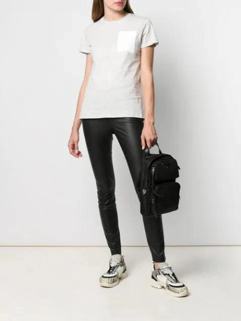Farfetch's Post | Wearing: Karl Lagerfeld Ikonik Karl Outline T-shirt In Grey; Prada Black One-shoulder Nylon Backpack; Alyx Snake-effect Leather Panelled Sneakers In White