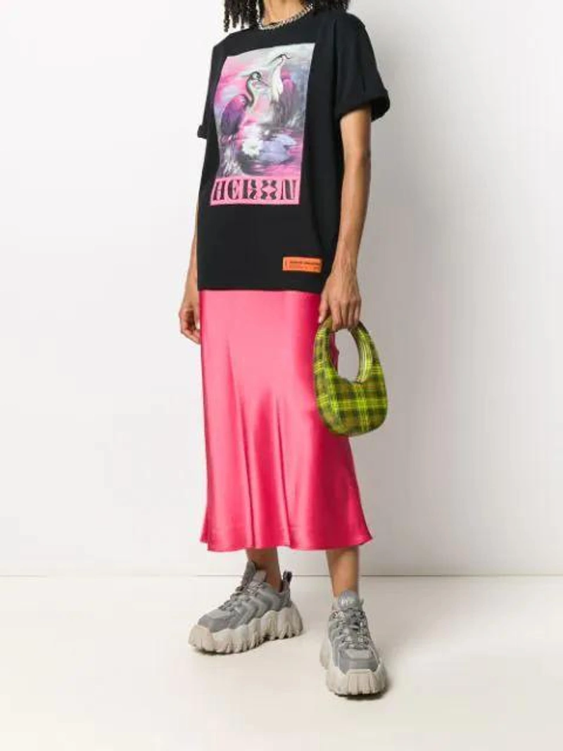 Farfetch's Post | Wearing: Heron Preston Black 'heron Print' T-shirt; Collina Strada Yod Satin Midi Skirt In Red; Coperni Swipe Mini Leather Shoulder Bag In Green,grey,red