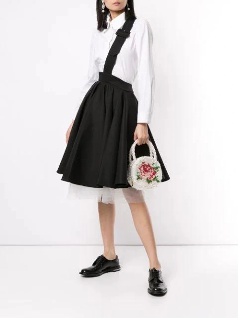 Farfetch's Post | Wearing: Shushu-tong Pleated Midi Skirt In Black; Comme Des Garçons Comme Des Garçons Asymmetric Hem Shirt In White; Shrimps Rosa Round Faux-pearl Bag In White