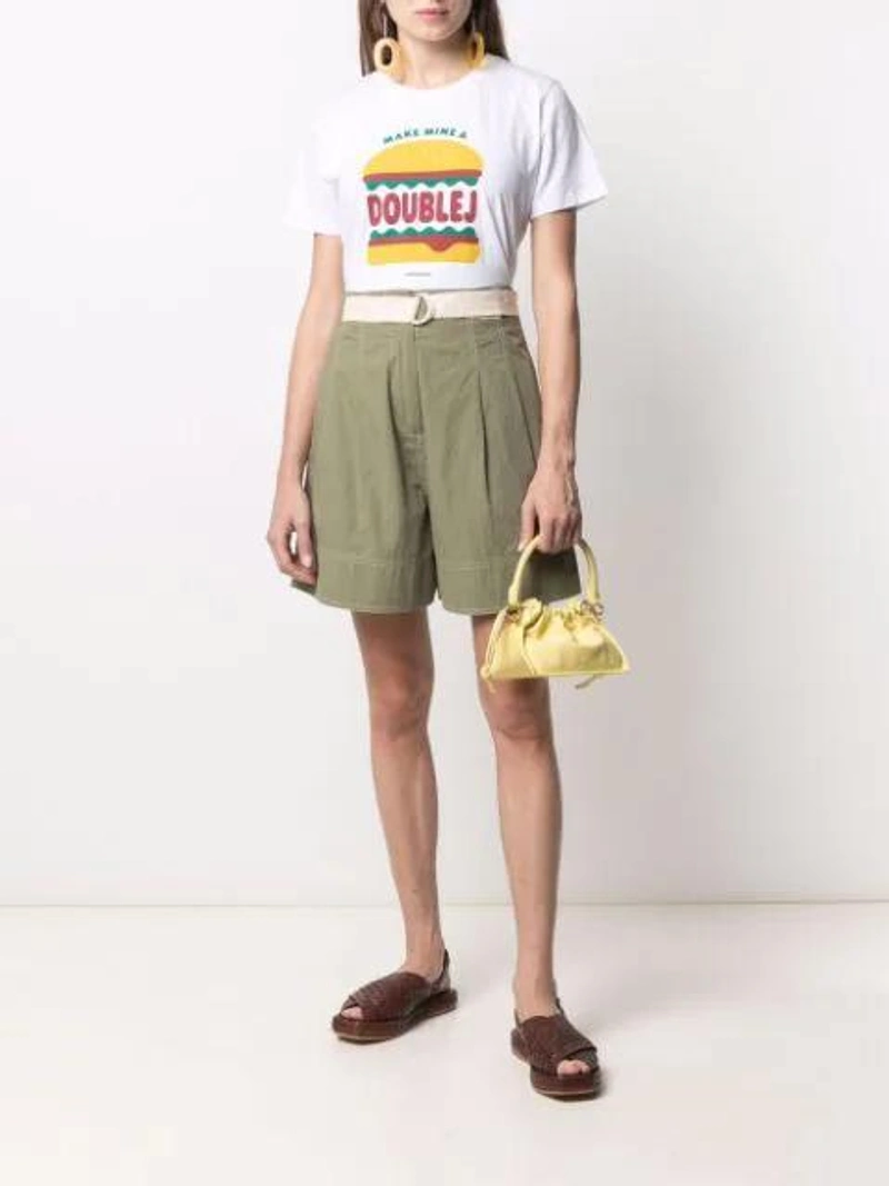 Farfetch's Post | Wearing: La Doublej Burger Slogan Print T-shirt In Make Mine A Doublej; Lee Mathews Birder Pleated Cotton-poplin Shorts In Green; St. Agni Brown Yona Woven Leather Sandals