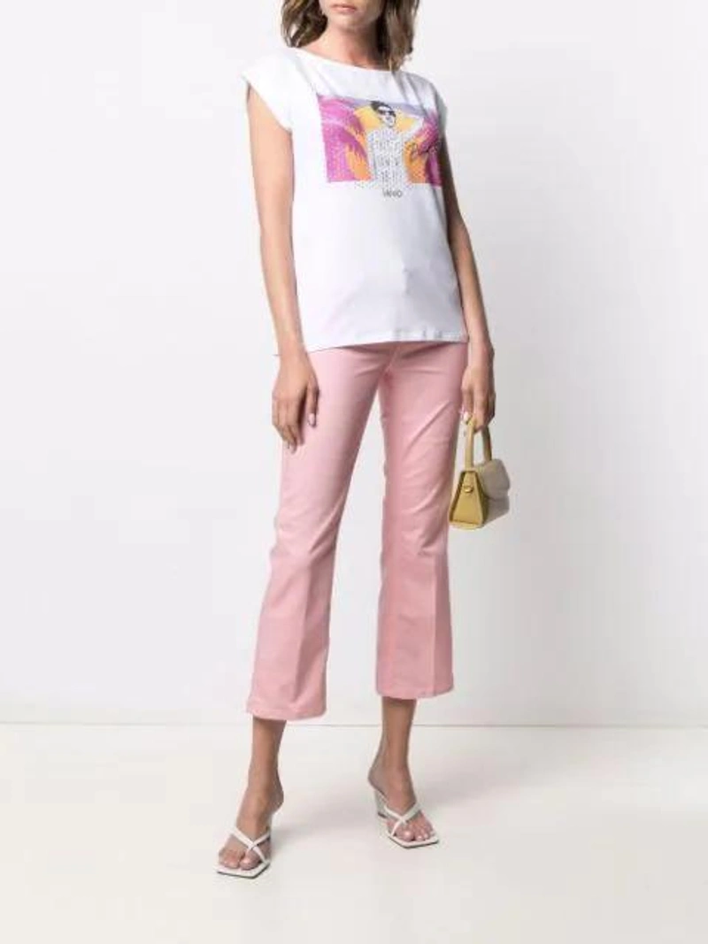 Farfetch's Post | Wearing: Liu •jo Crystal-embellished Graphic Print T-shirt In White; Liu •jo Low-rise Cropped Jeans In Pink; By Far Sky Mini Lizard Bag In Yellow