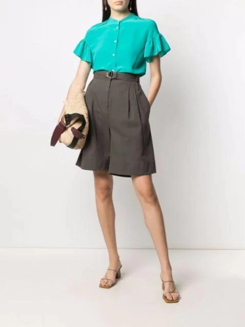 Farfetch's Post | Wearing: Aspesi Ruffled Sleeves Silk Blouse In Green; Tibi Khaki Gabardine Stella Shorts In Green Grey; Isabel Marant Bayia Raffia Tote Bag In Neutrals