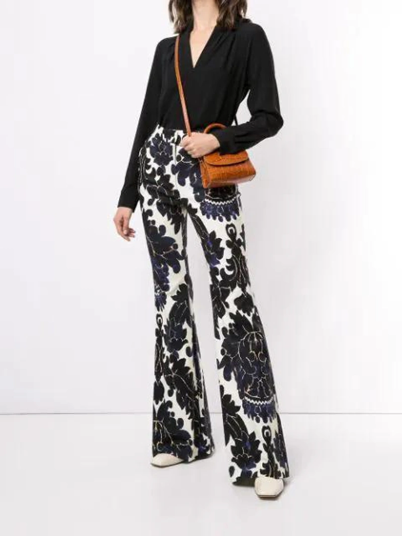 Farfetch's Post | Wearing: Adam Lippes V-neck Blouse In Black; Adam Lippes Floral-print Flared Trousers In Blue; By Far Grey Rachel Snake Effect Shoulder Bag In Brown