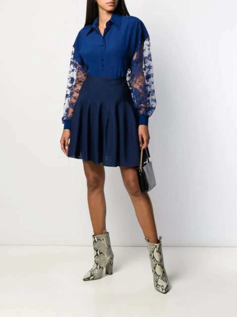 Farfetch's Post | Wearing: Givenchy Floral Lace Long-sleeved Blouse In Blue; Givenchy Sculpted Scuba Jersey Drop-waist Skirt In Dark Blue; Alexander Mcqueen Mini Skull Croc-effect Cross-body Bag In Black
