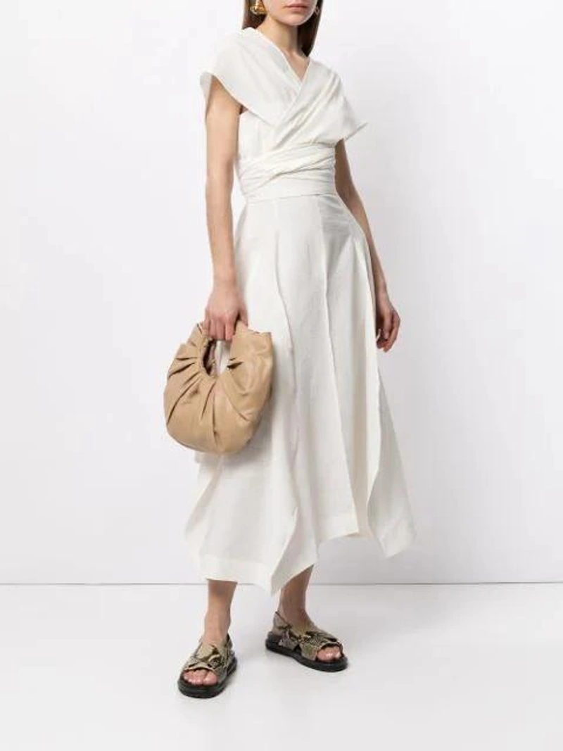 Farfetch's Post | Wearing: Gia Studios Wrap-neckline Dress In White; Gia Studios Croissant Ruched-detail Clutch Bag In Brown; Jil Sander Gold Tone Fluid Folded Earrings