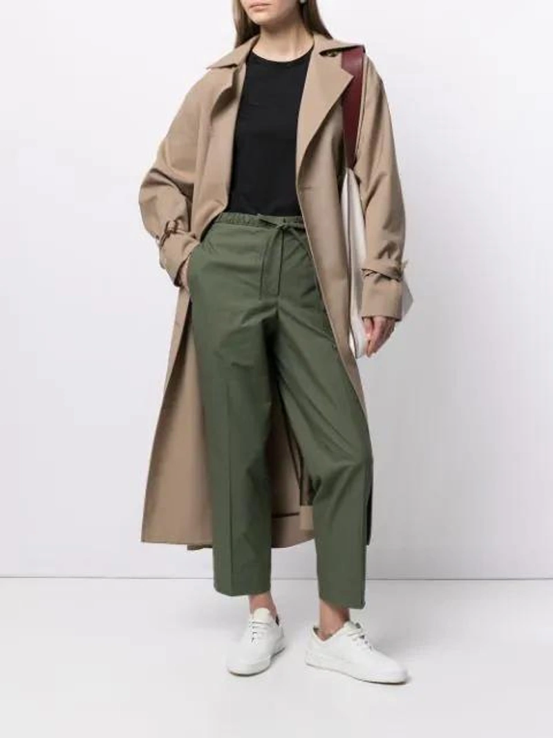 Farfetch's Post | Wearing: Jil Sander Chunky Sole Lace-up Sneakers In White; Jil Sander + Logo Embroidered T-shirt In Black; Jil Sander Drawstring-waist Cotton Trousers In Green
