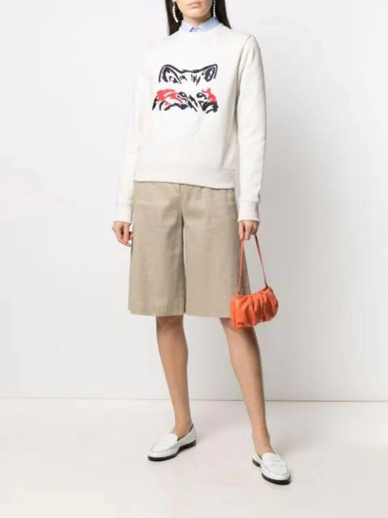 Farfetch's Post | Wearing: Hommegirls X Browns 50 Cropped Cotton Shirt In Blue; Maison Kitsuné Abstract Fox Print Sweatshirt In White; Joseph Long Wide-leg Shorts In Neutrals