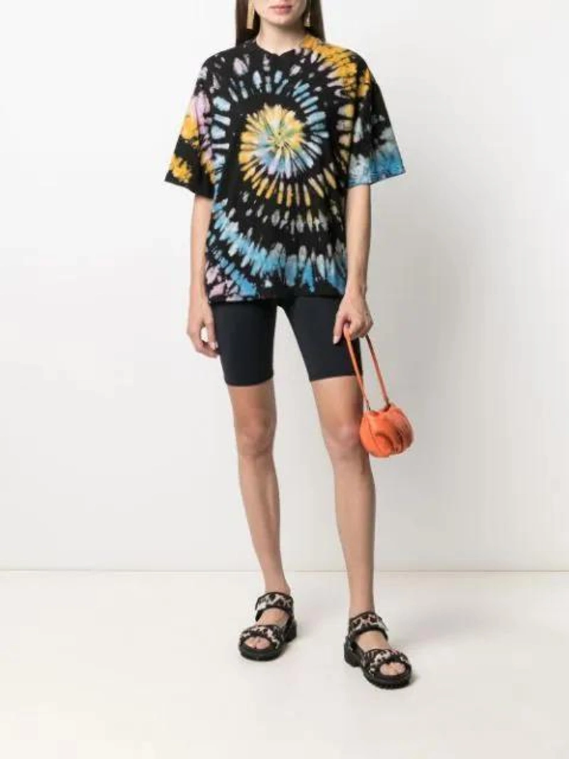 Farfetch's Post | Wearing: Electric & Rose Cali Biker Shorts In Black; Electric & Rose Luna Tie-dye T-shirt In Black; Staud Bean Convertible Leather Clutch Bag In Nectarine
