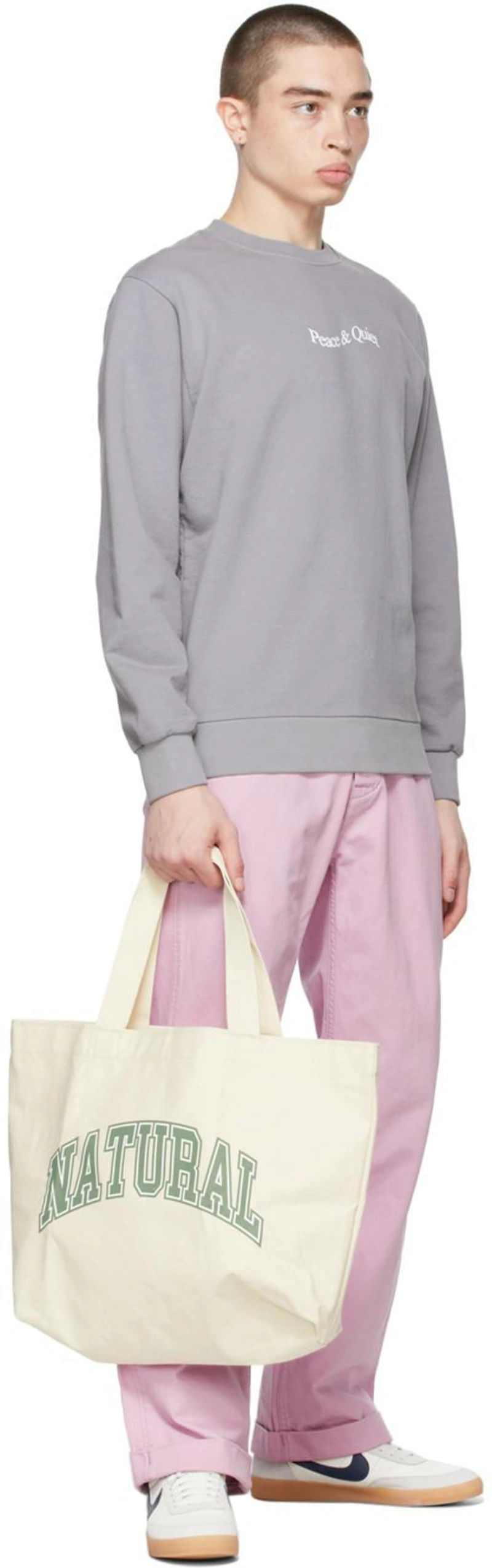 SSENSE's Post | Wearing: Levi's Pink '20s Chino Trousers In Mauve Mist; Museum Of Peace And Quiet Grey Word Mark Sweatshirt In Charcoal; Museum Of Peace And Quiet Ssense Exclusive Off-white 'natural' Tote