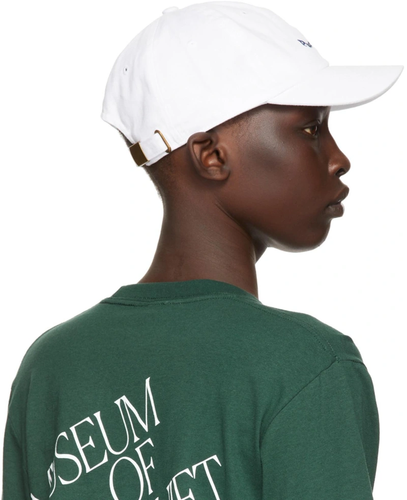 SSENSE's Post | Wearing: Museum Of Peace And Quiet Green Cotton 'arts + Leisure' Long Sleeve T-shirt In Forest; Museum Of Peace And Quiet Ssense Exclusive White Mini Wordmark Cap