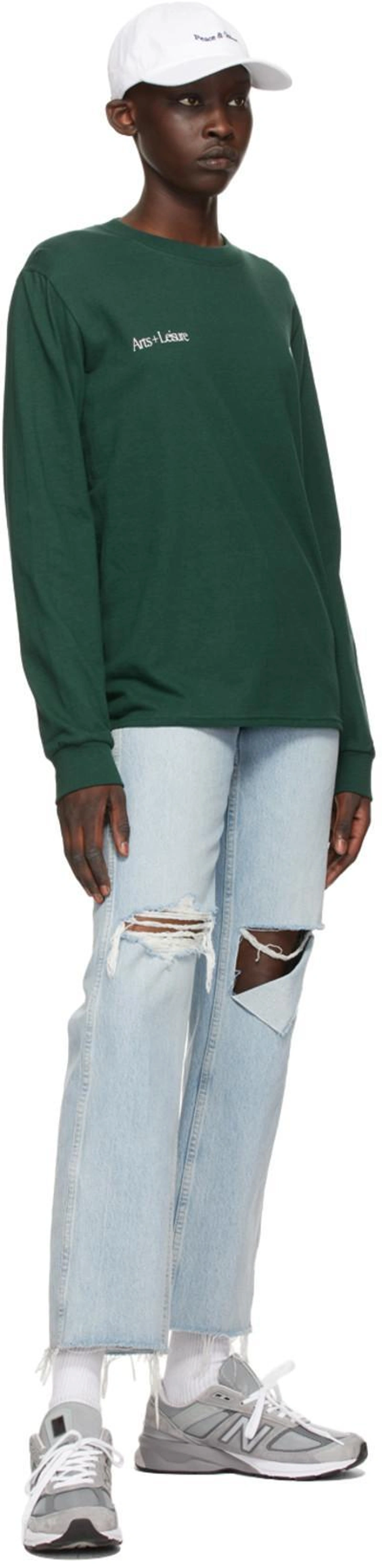 SSENSE's Post | Wearing: Re/done 90s Loose Straight Cropped Distressed Mid-rise Jeans In Bleach Destroy; Museum Of Peace And Quiet Green Cotton 'arts + Leisure' Long Sleeve T-shirt In Forest; Museum Of Peace And Quiet Ssense Exclusive White Mini Wordmark Cap
