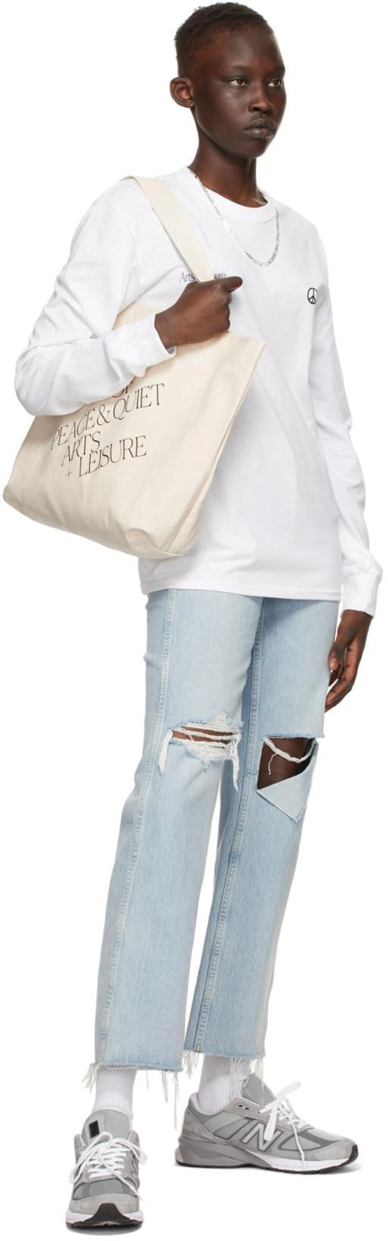 SSENSE's Post | Wearing: Re/done 90s Loose Straight Cropped Distressed Mid-rise Jeans In Bleach Destroy; Museum Of Peace And Quiet White Cotton 'arts + Leisure' Long Sleeve T-shirt; Museum Of Peace And Quiet Off-white 'arts + Leisure' Tote In Natural Canvas