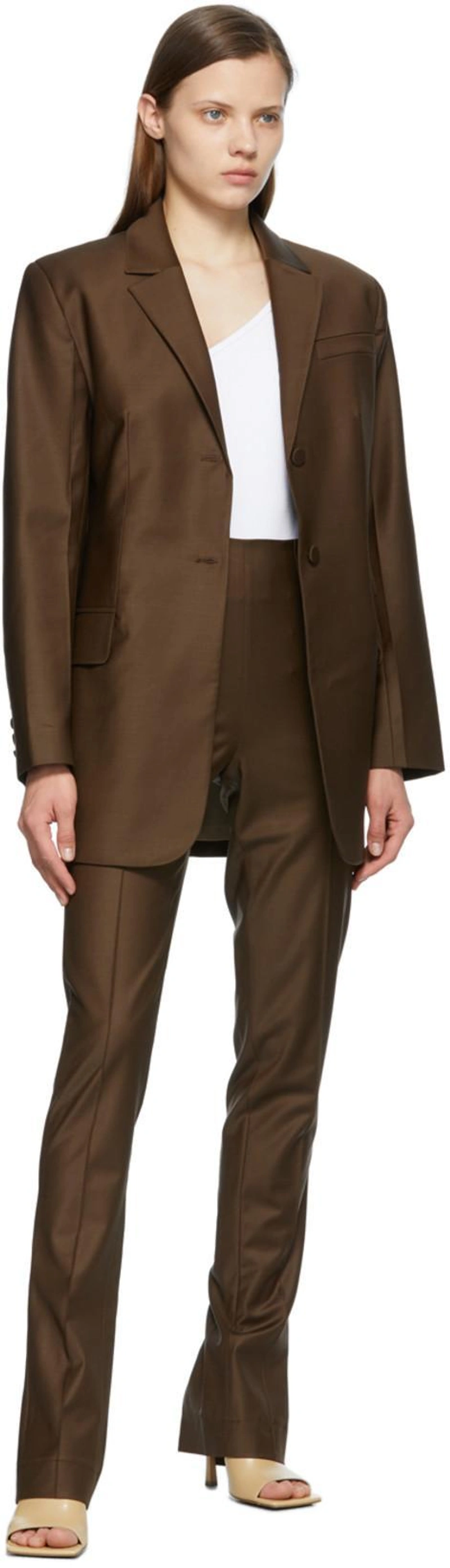 SSENSE's Post | Wearing: Matériel Tbilisi Brown Tropical Wool Menswear Blazer; Matériel Tbilisi Brown Tropical Wool Slit Trousers; Matériel Tbilisi White One Shoulder Rib Bodysuit